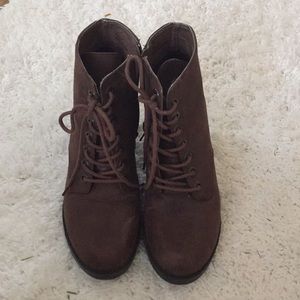 A pair of lace up booties